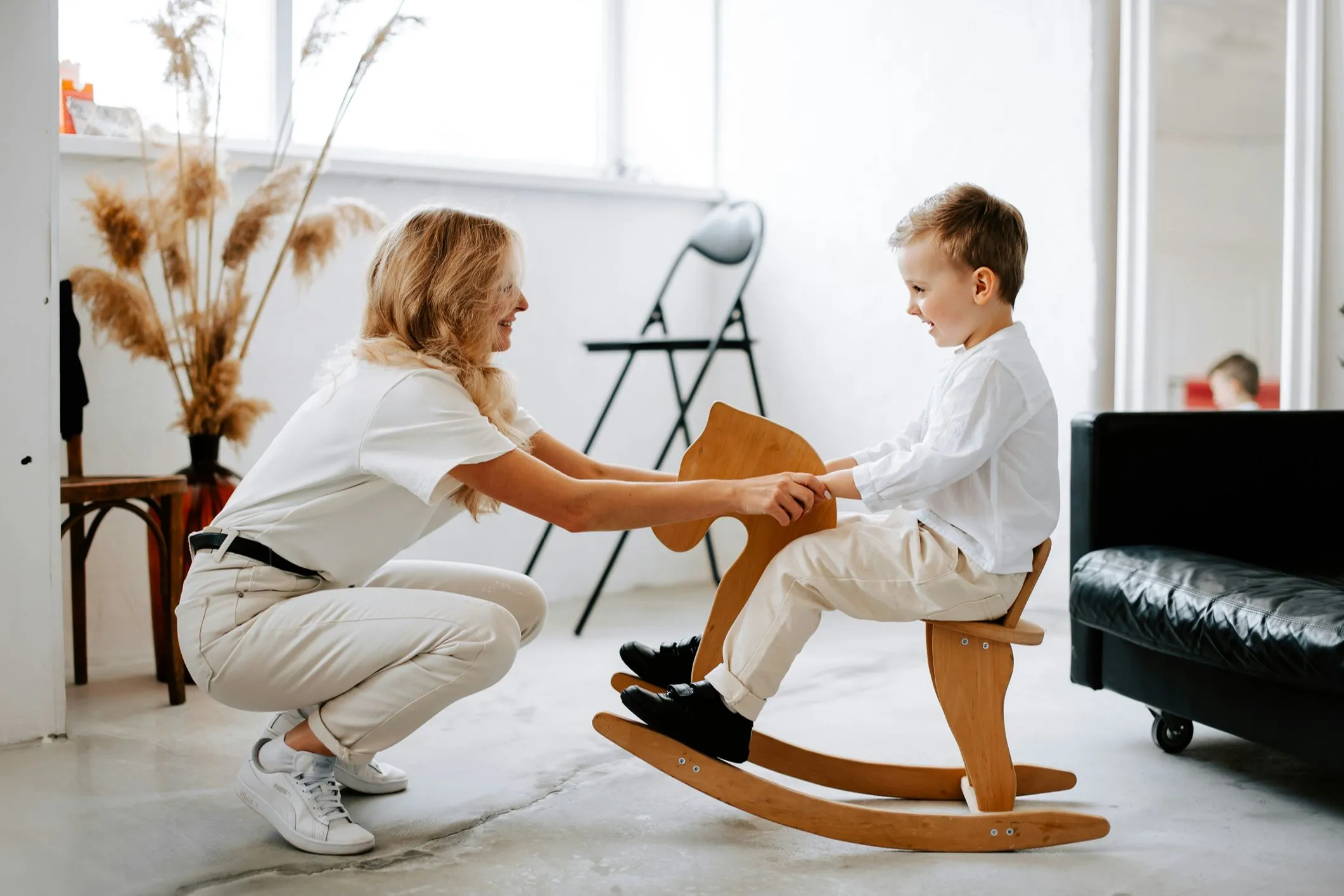 Smiling child on wooden rocker